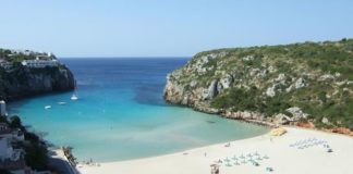 Cala en Porter – Feriensiedlung mit Höhlendisco Blick von oben auf den Strand von Calan Porter, Menorca
